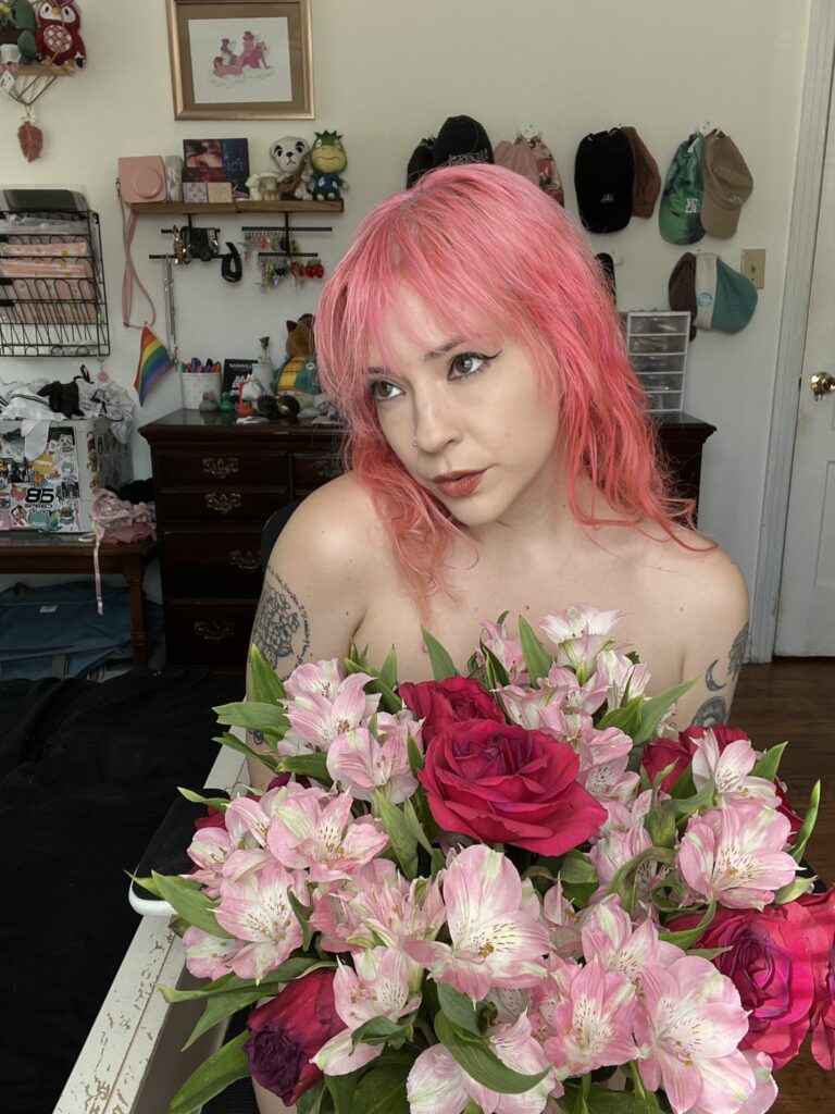 Amatuer porn creator Lil Red Velvet posing with flowers
